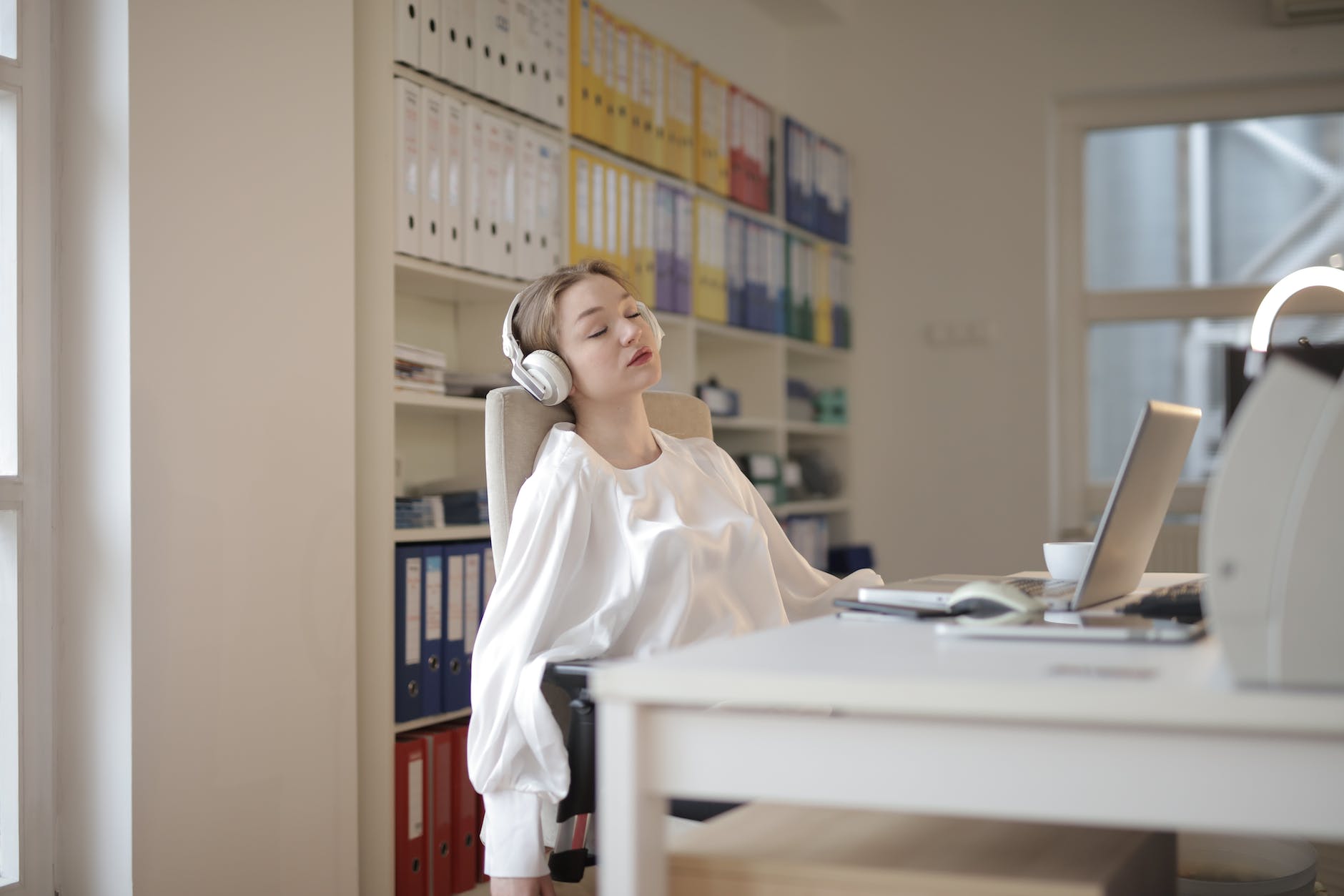 woman in white dress shirt sitting on chair