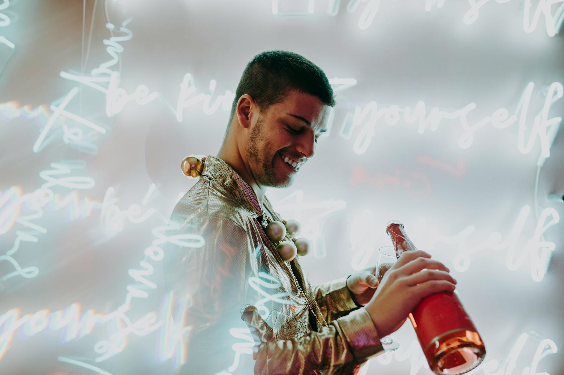 smiling man pouring wine on a glass