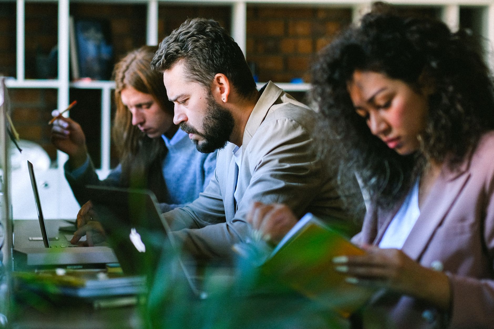 group of focused colleagues working together in office