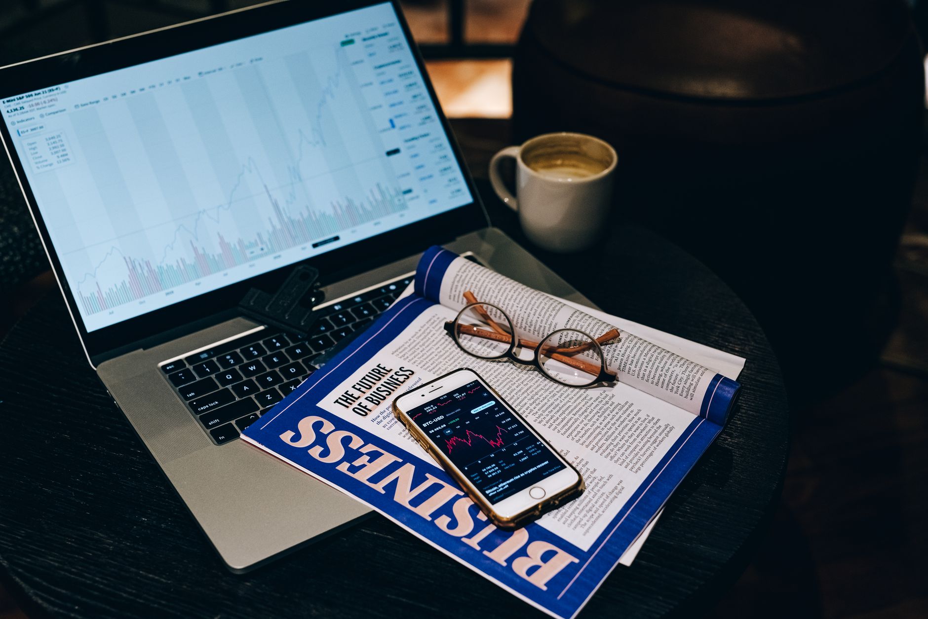 newsletter with smartphone and eyeglasses on laptop