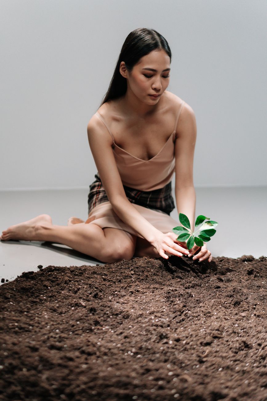 a woman in a dress planting