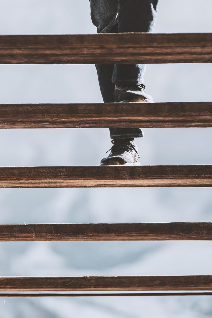 person wearing black leather shoes