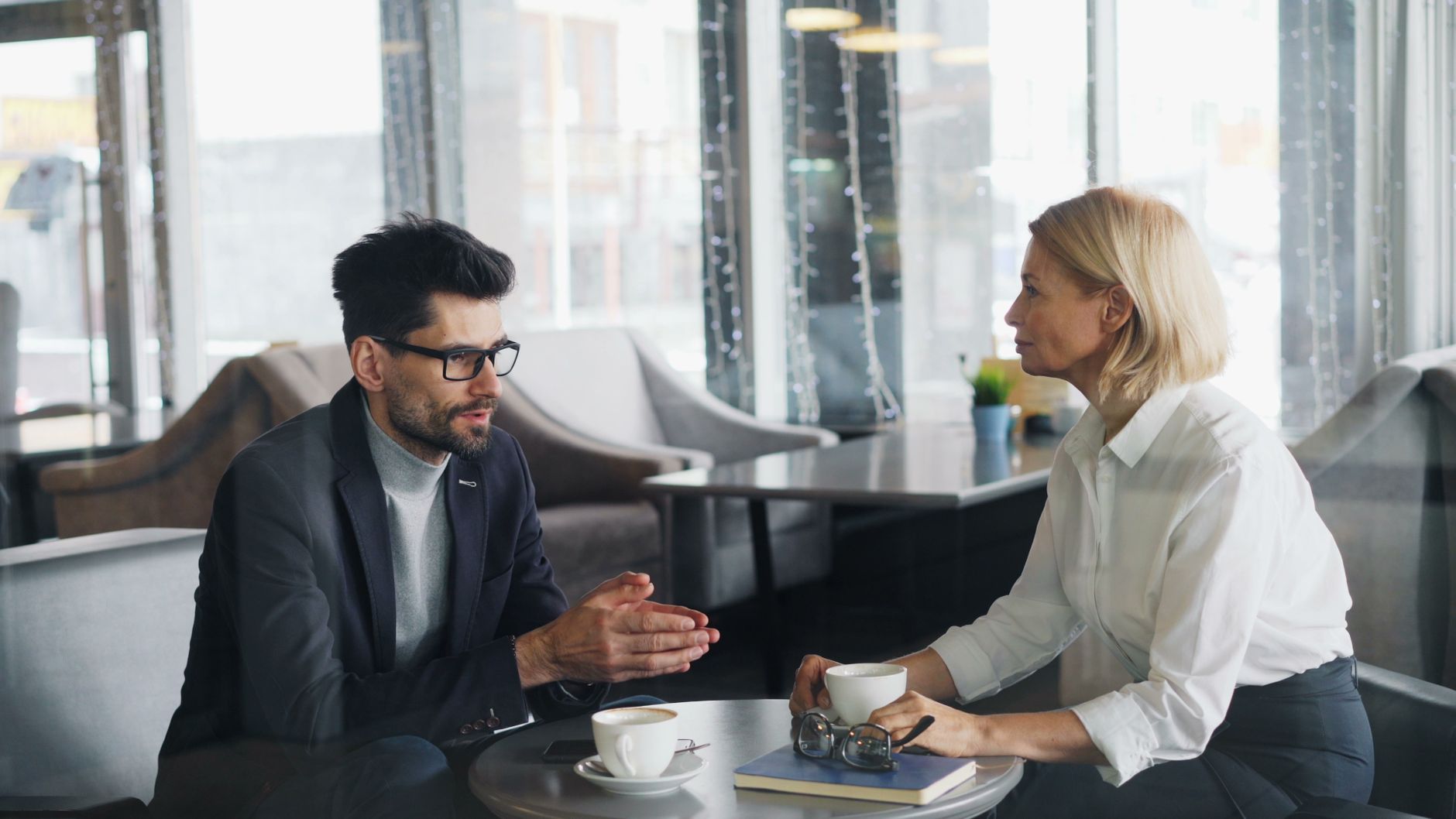 woman and man sitting at office