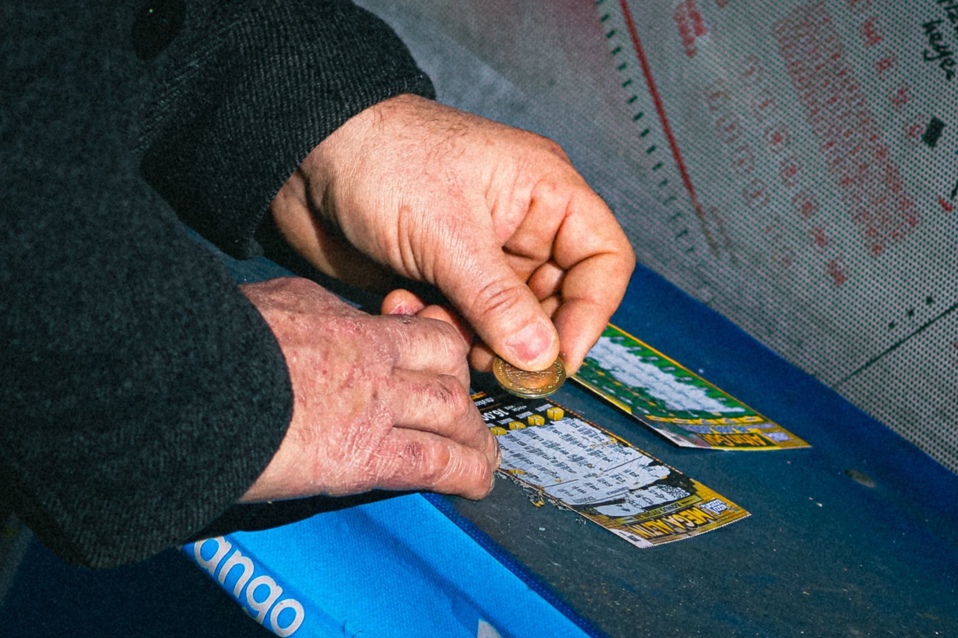 close up of hands scratching lottery tickets