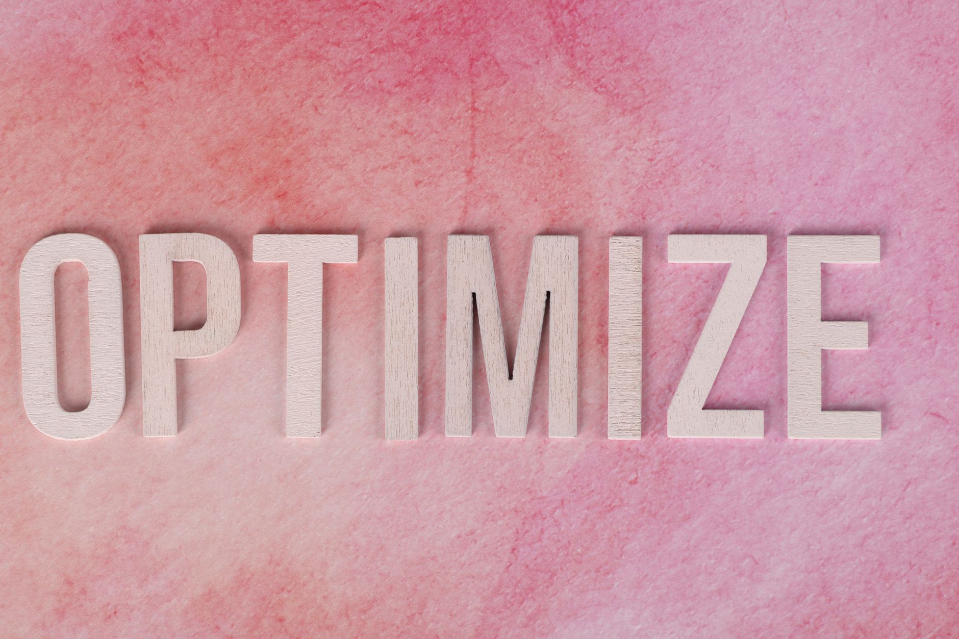 optimize concept on pink textured background