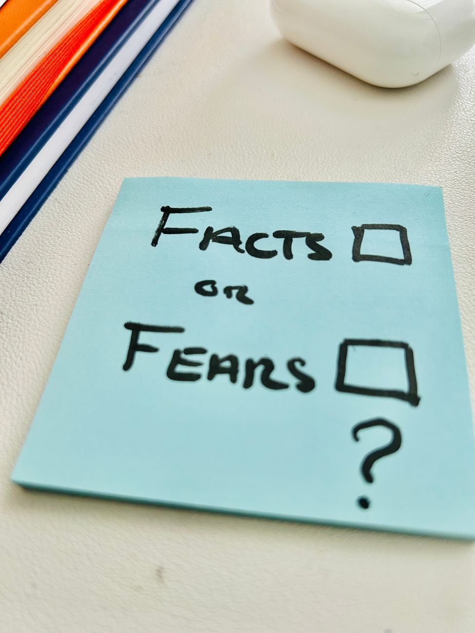 blue sticky note with facts or fears text
