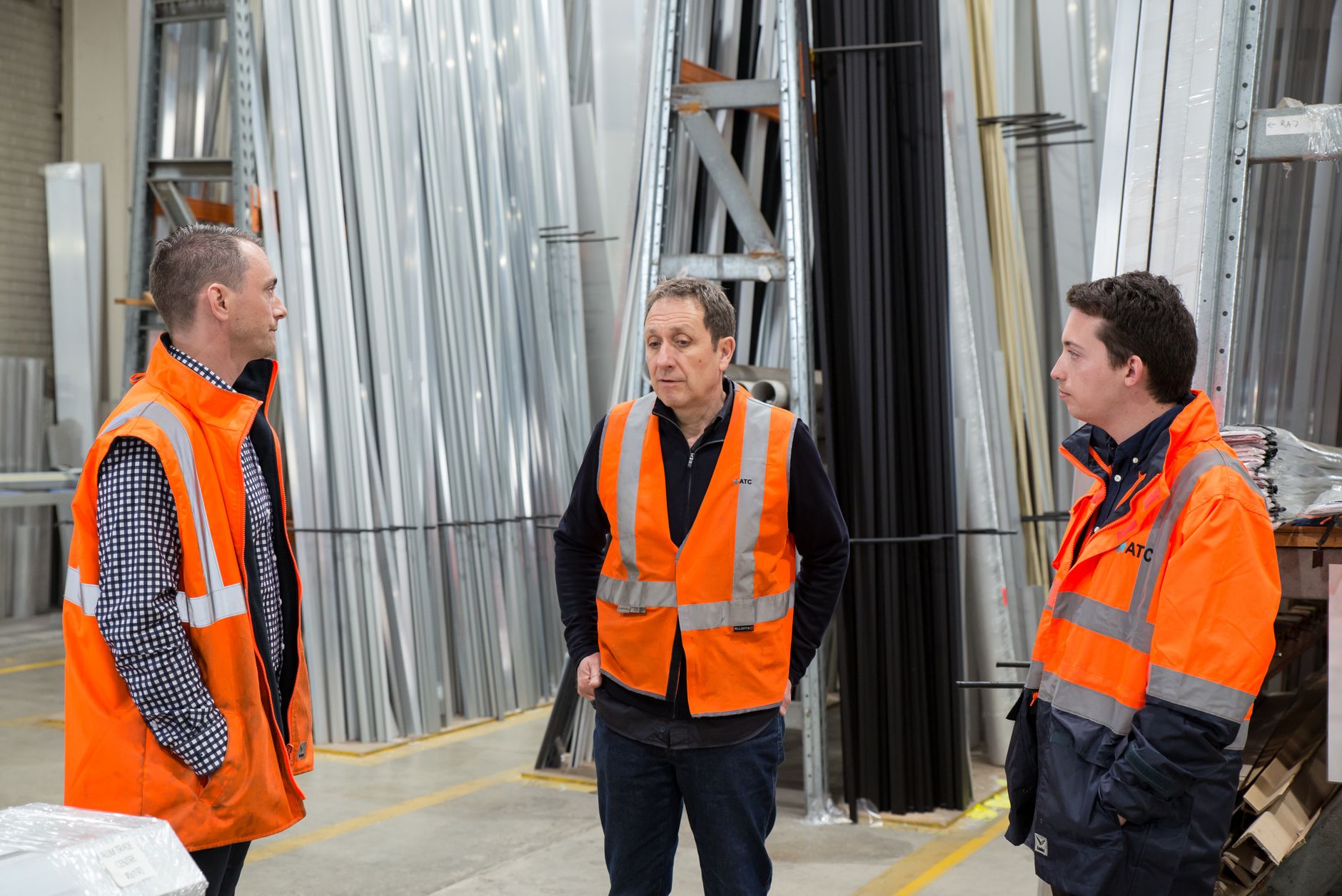 warehouse team in safety gear discussing work