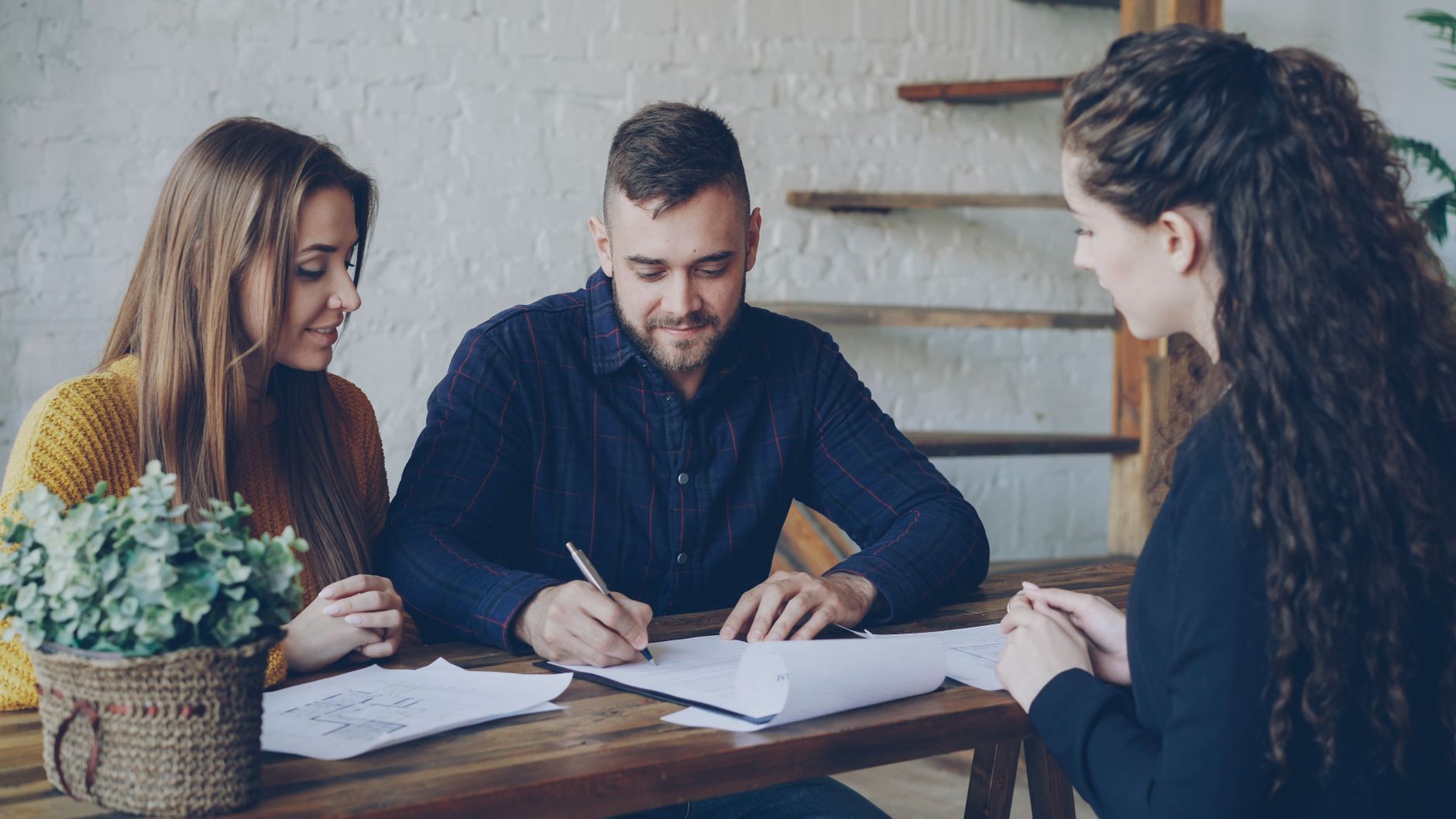 young couple meeting with real estate agent