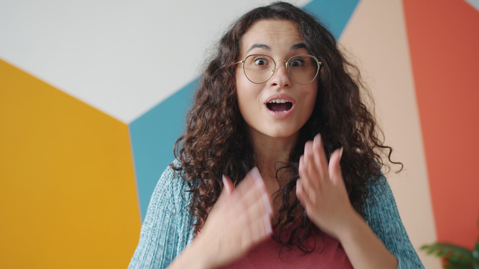 surprised woman with colorful geometric background