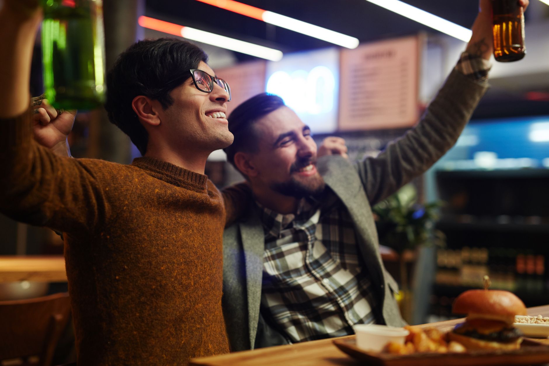 men celebrating at a bar