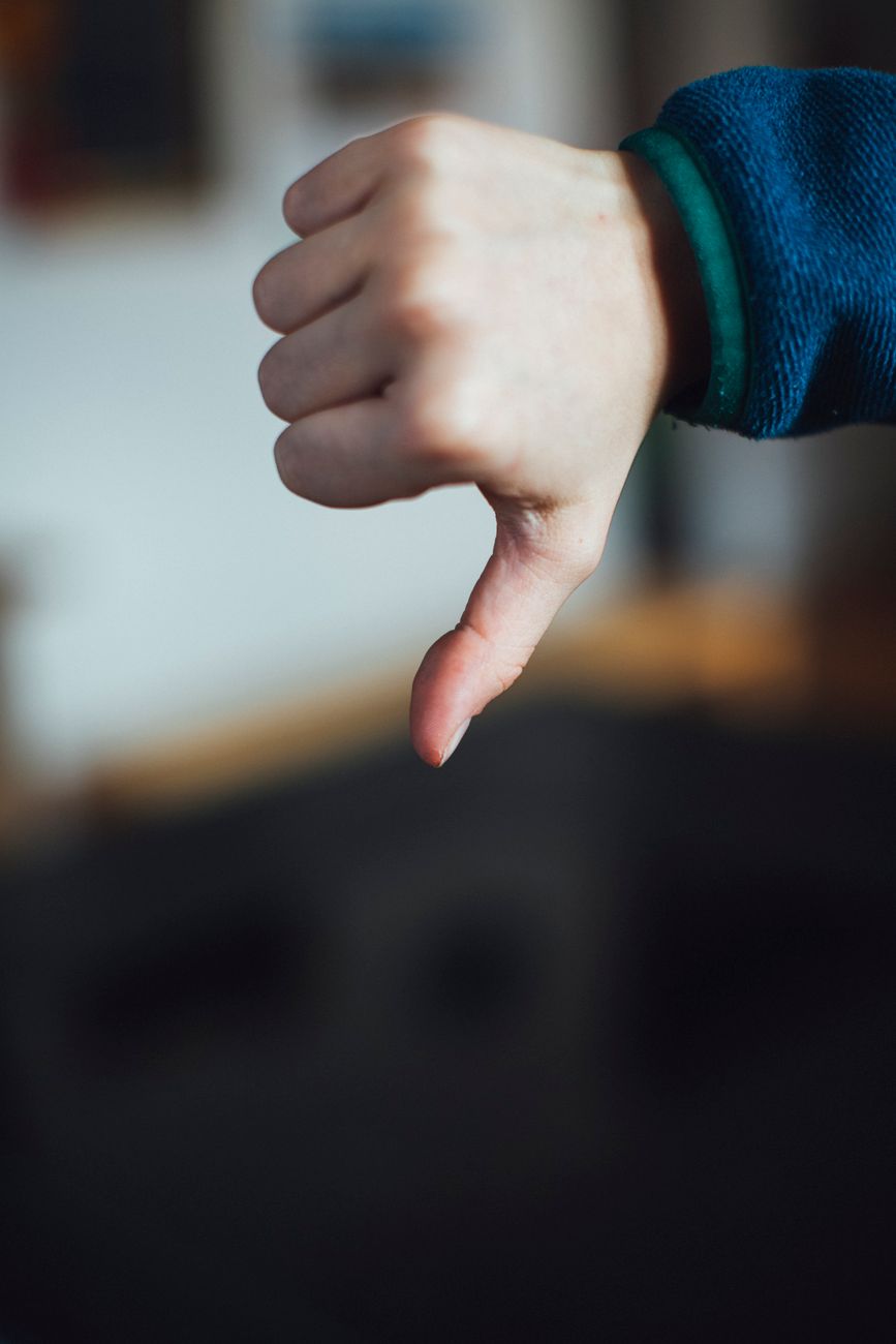 person doing thumbs down