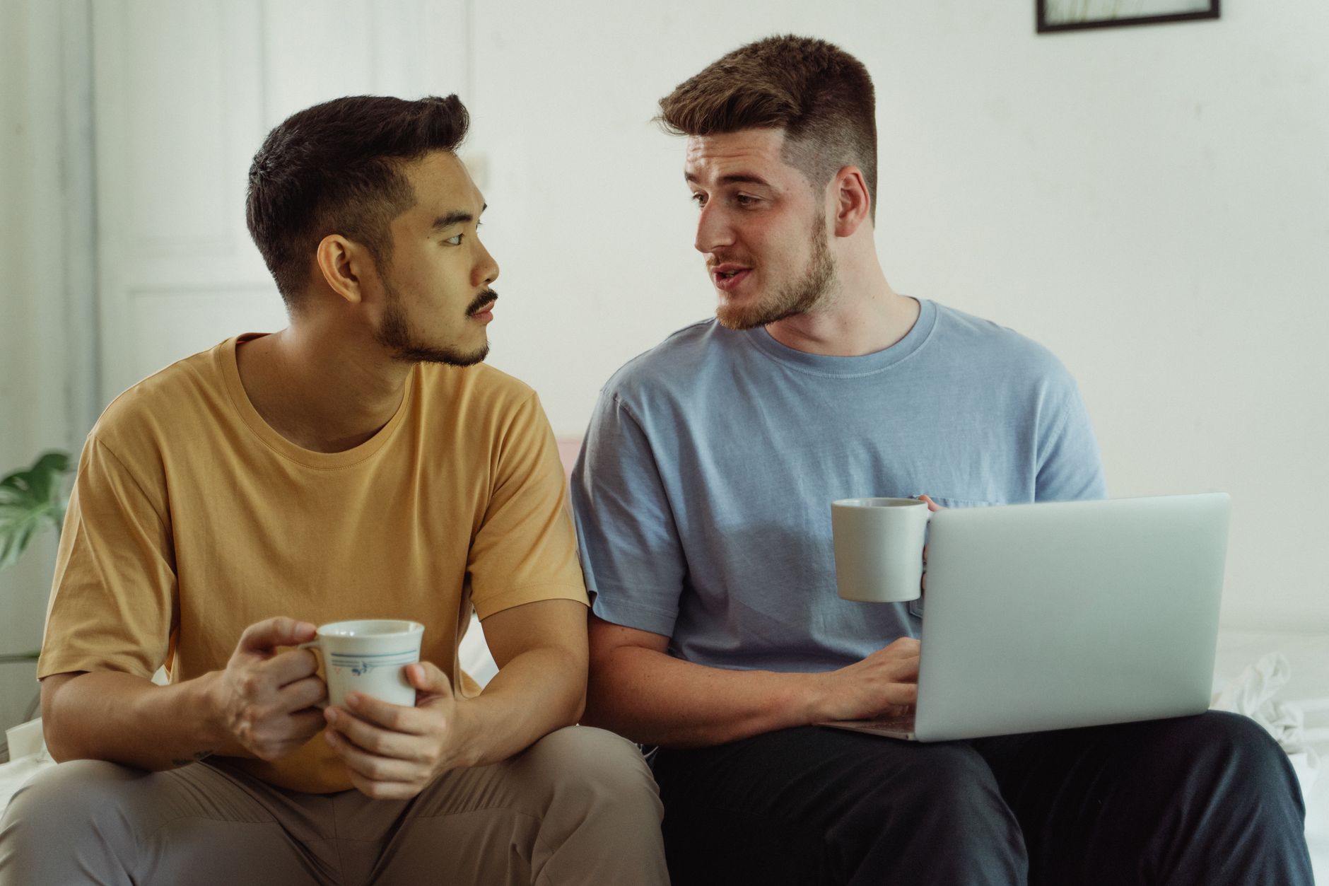 men drinking coffee and using laptop