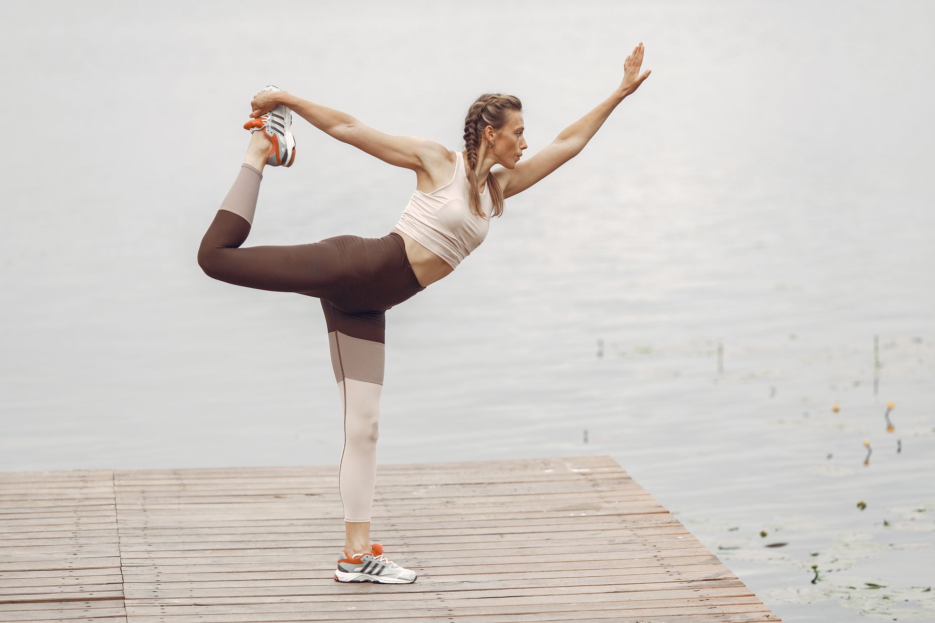 woman stretching on a pier