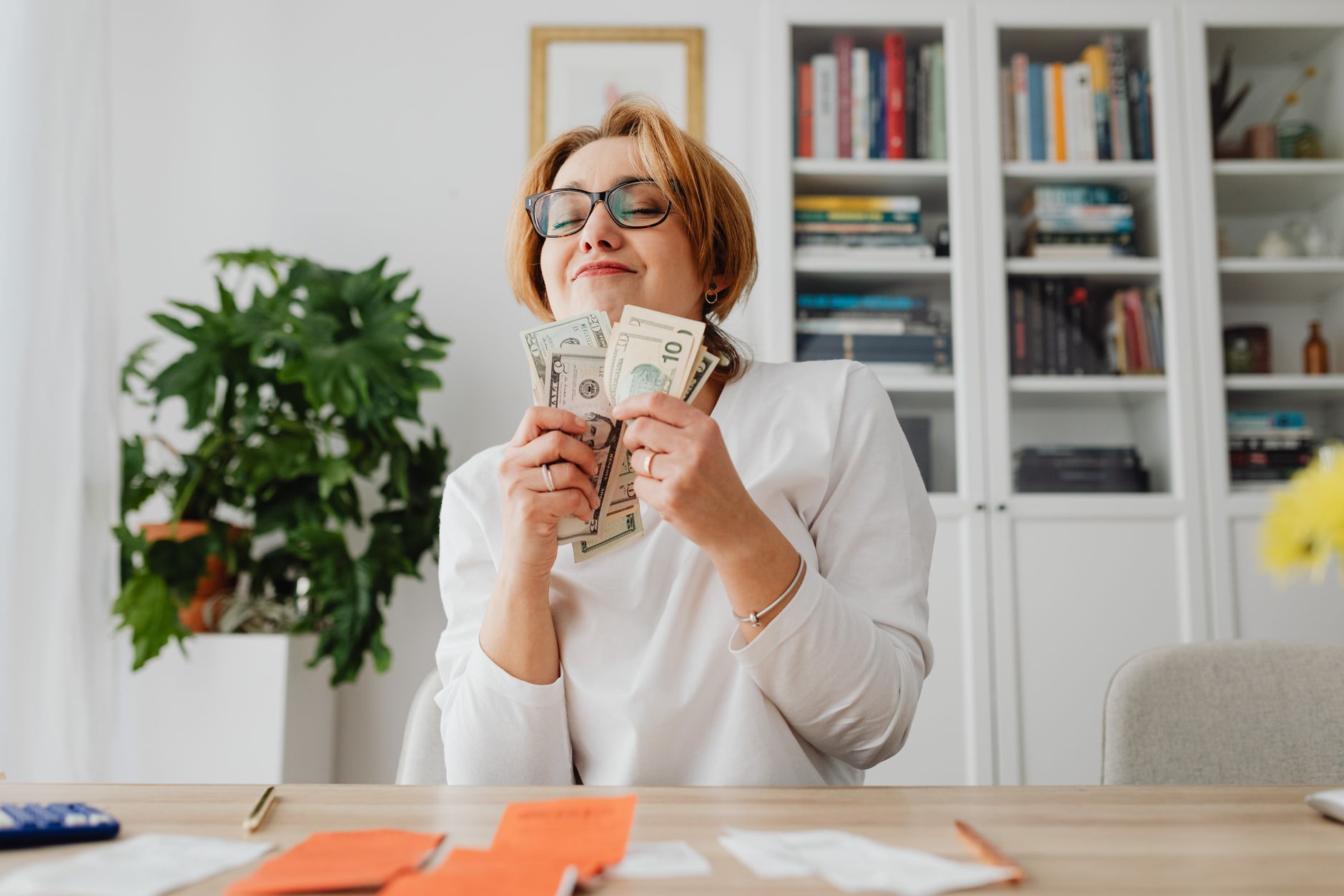 woman holding dollar bills smiling