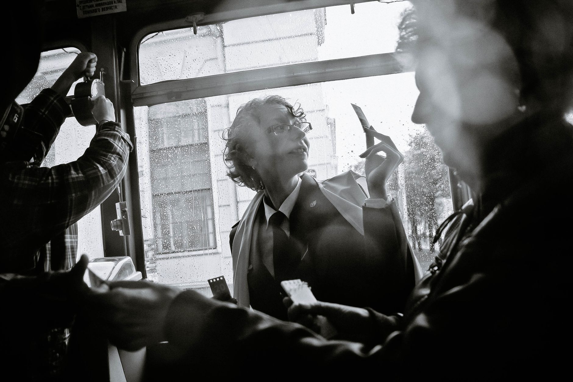 unrecognizable passengers commuting in old public transport in sunlight