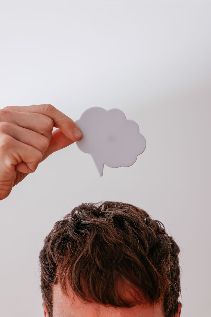 a person holding a thought bubble