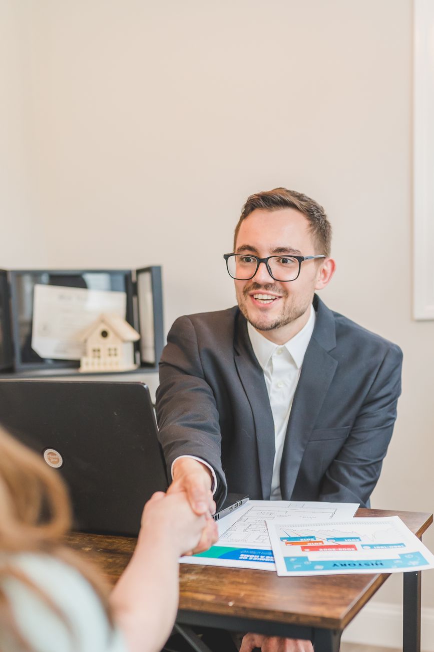 man in black suit jacket wearing eyeglasses