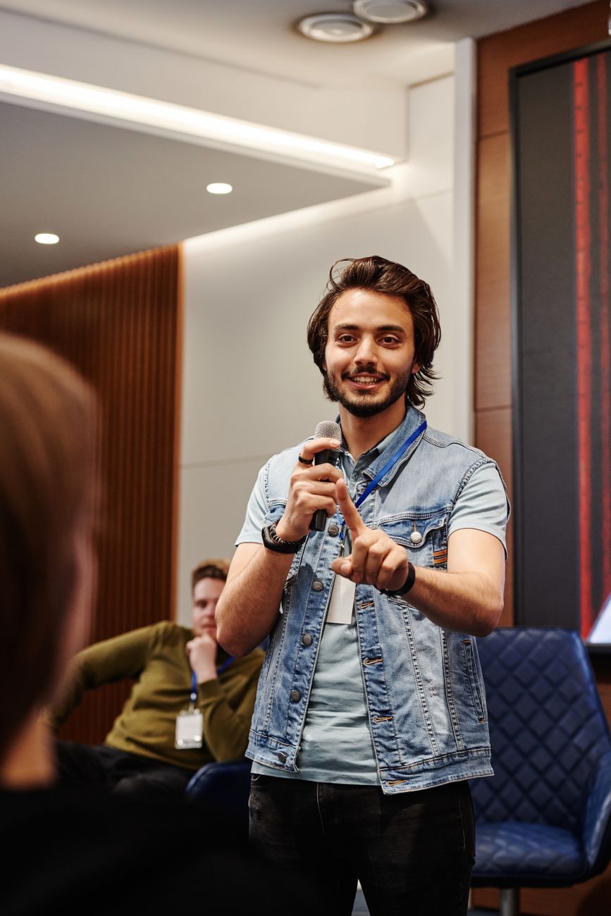 smiling man talking through microphone