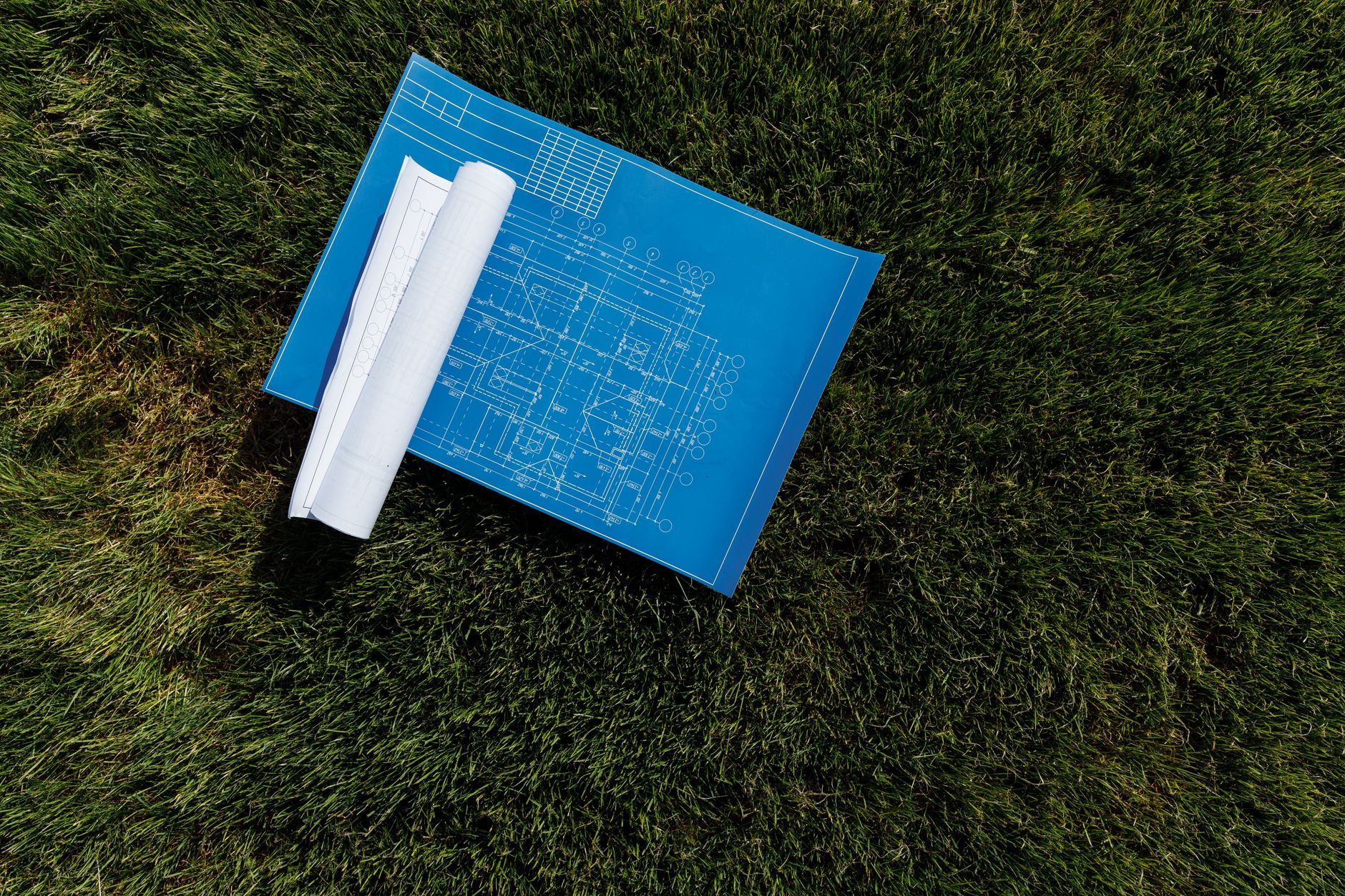blueprint on a grassy ground