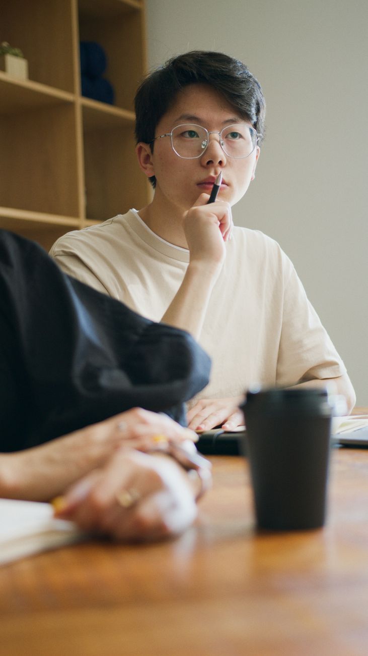 man wearing eyeglasses thinking