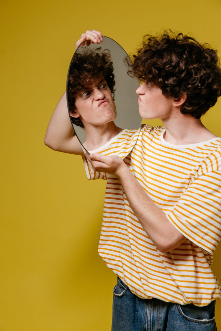 a man holding a mirror