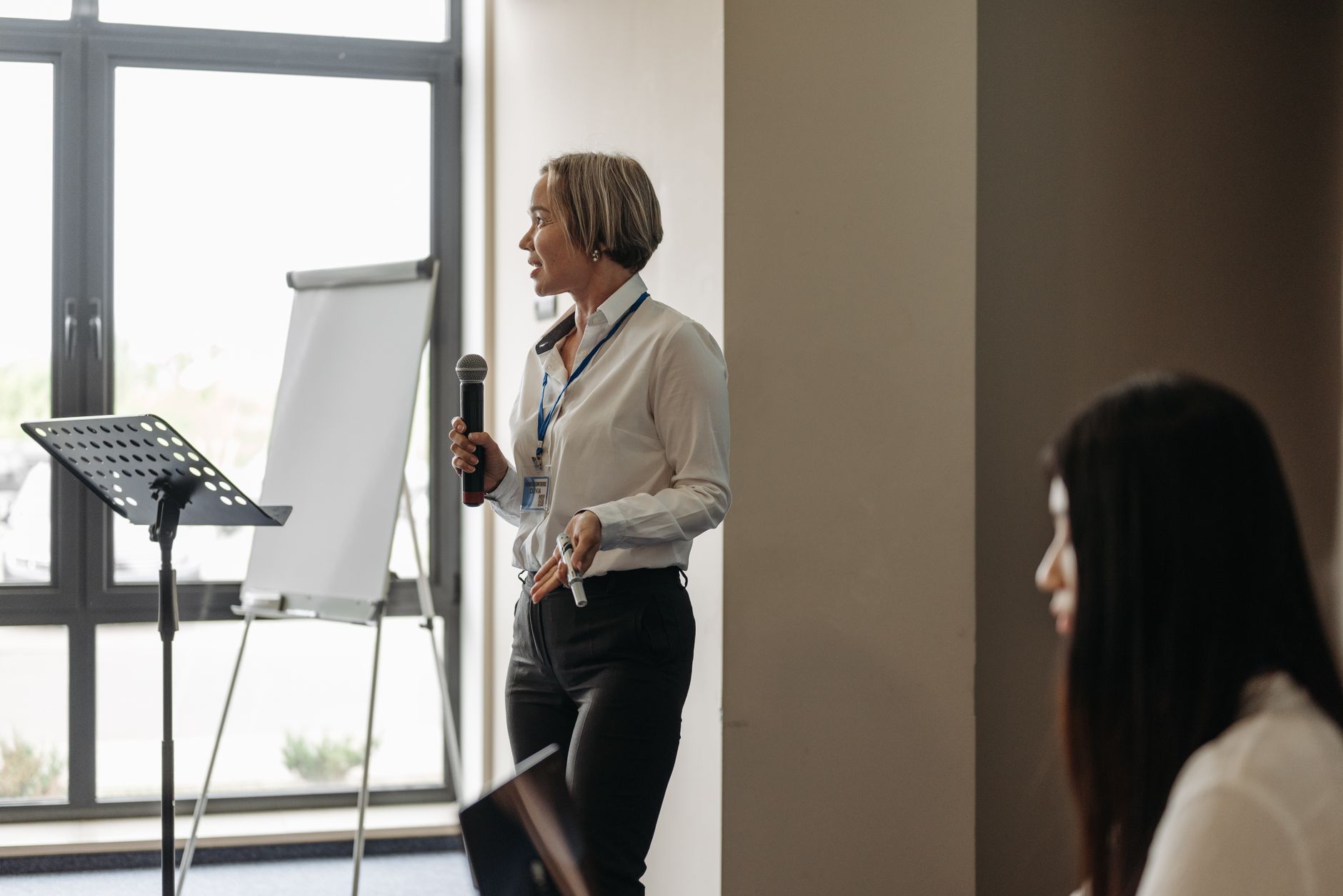 a woman talking with a microphone