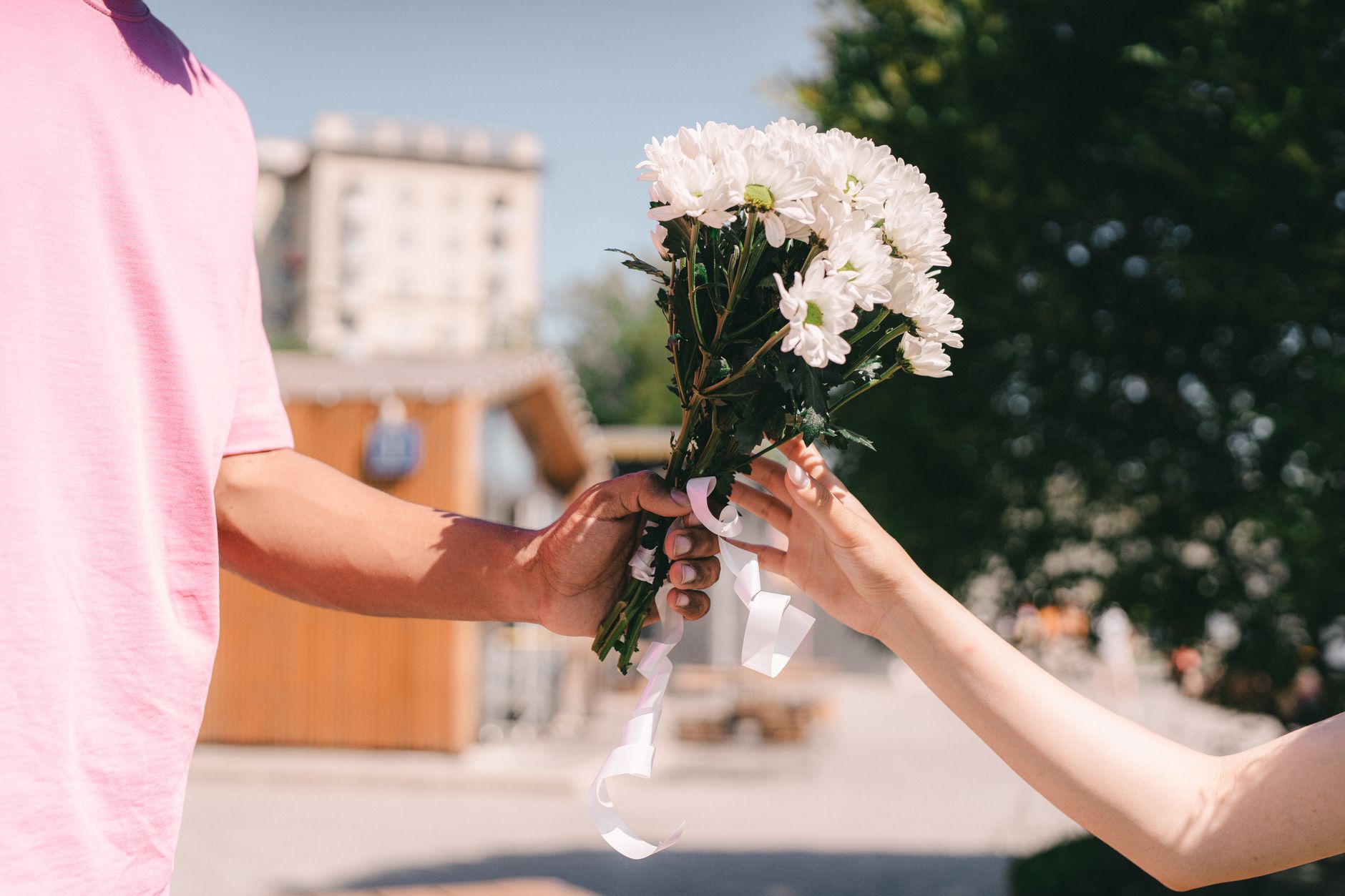 person holding white flower bouquet