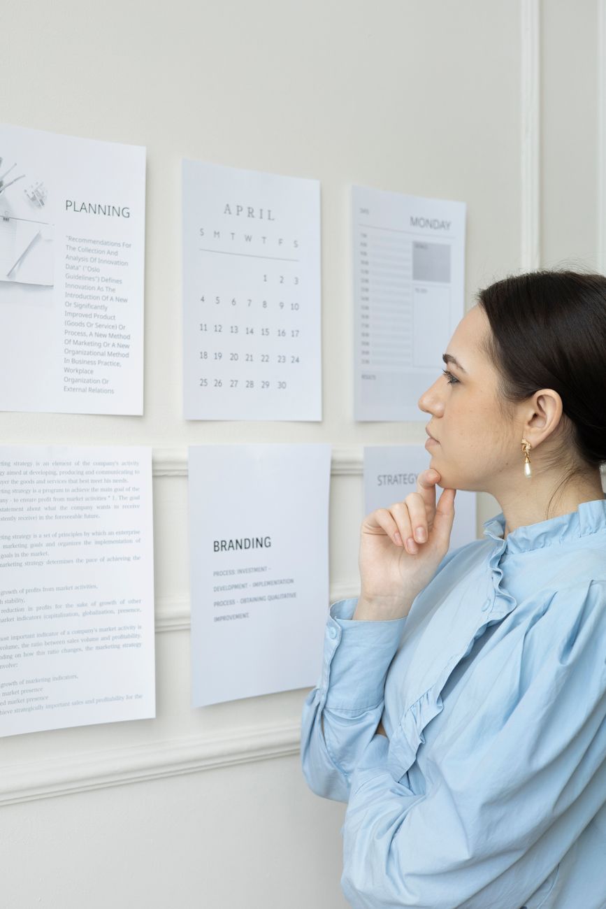a woman thinking while looking at paper