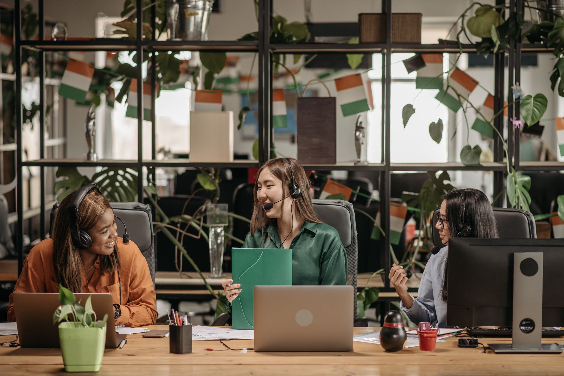 women in headsets talking at their workplace